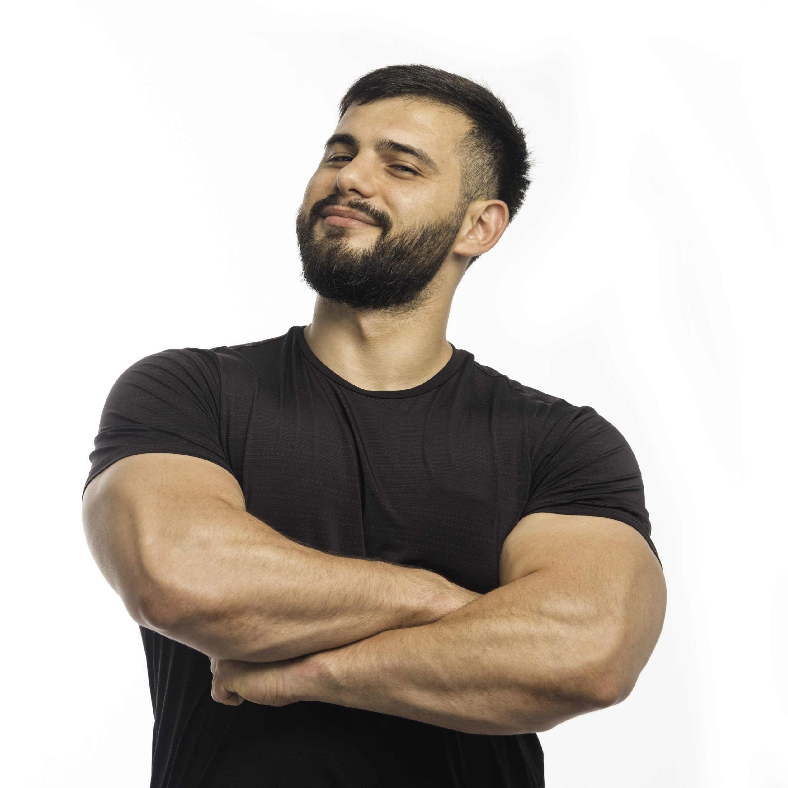 Sportive man in black shirt closing his arm muscles. High quality photo